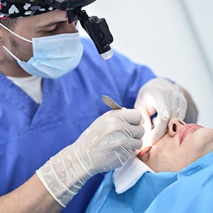 doctor performing procedure on woman's face